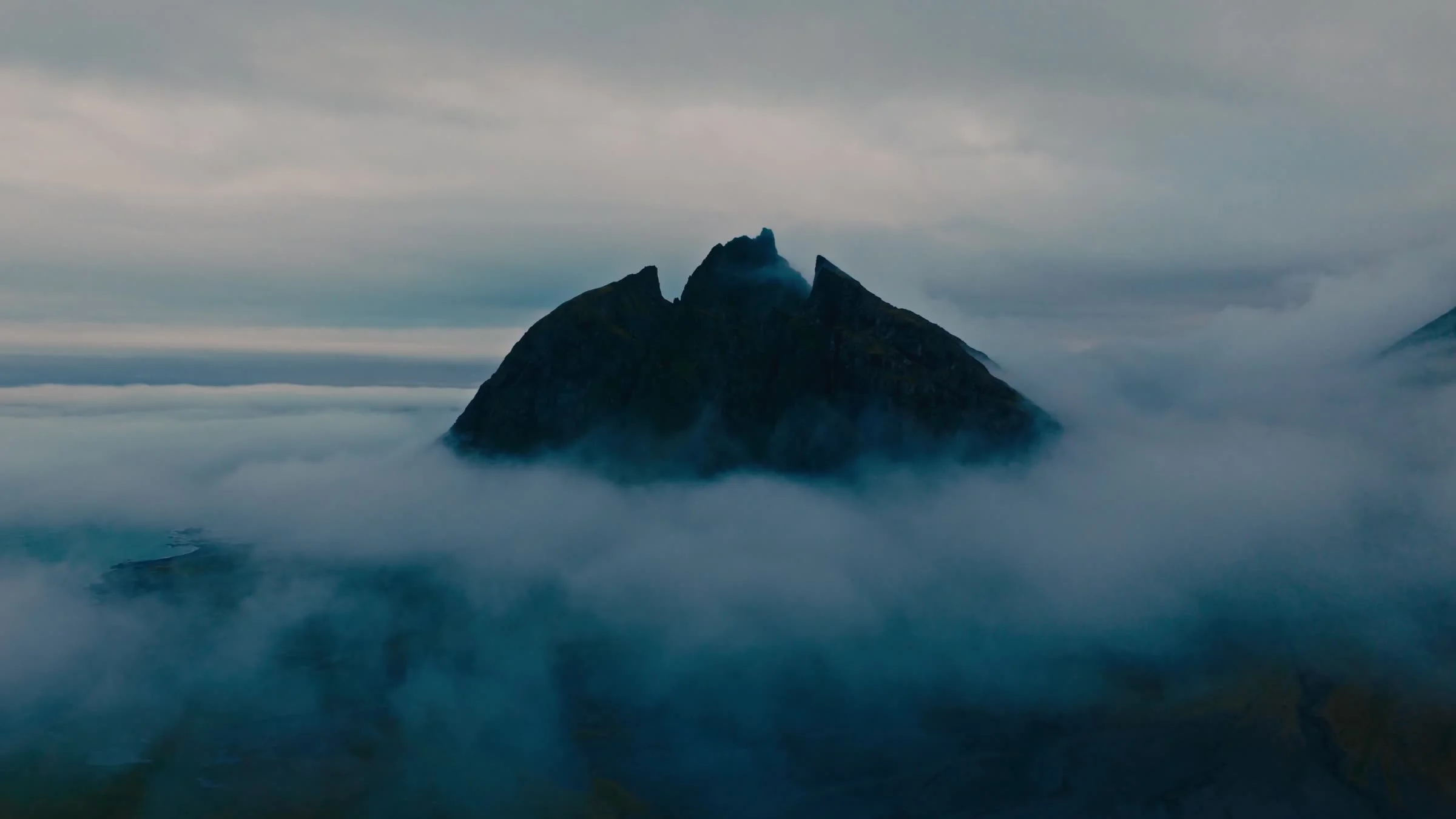 Icelandic mountain peaks emerging through a sea of cloud