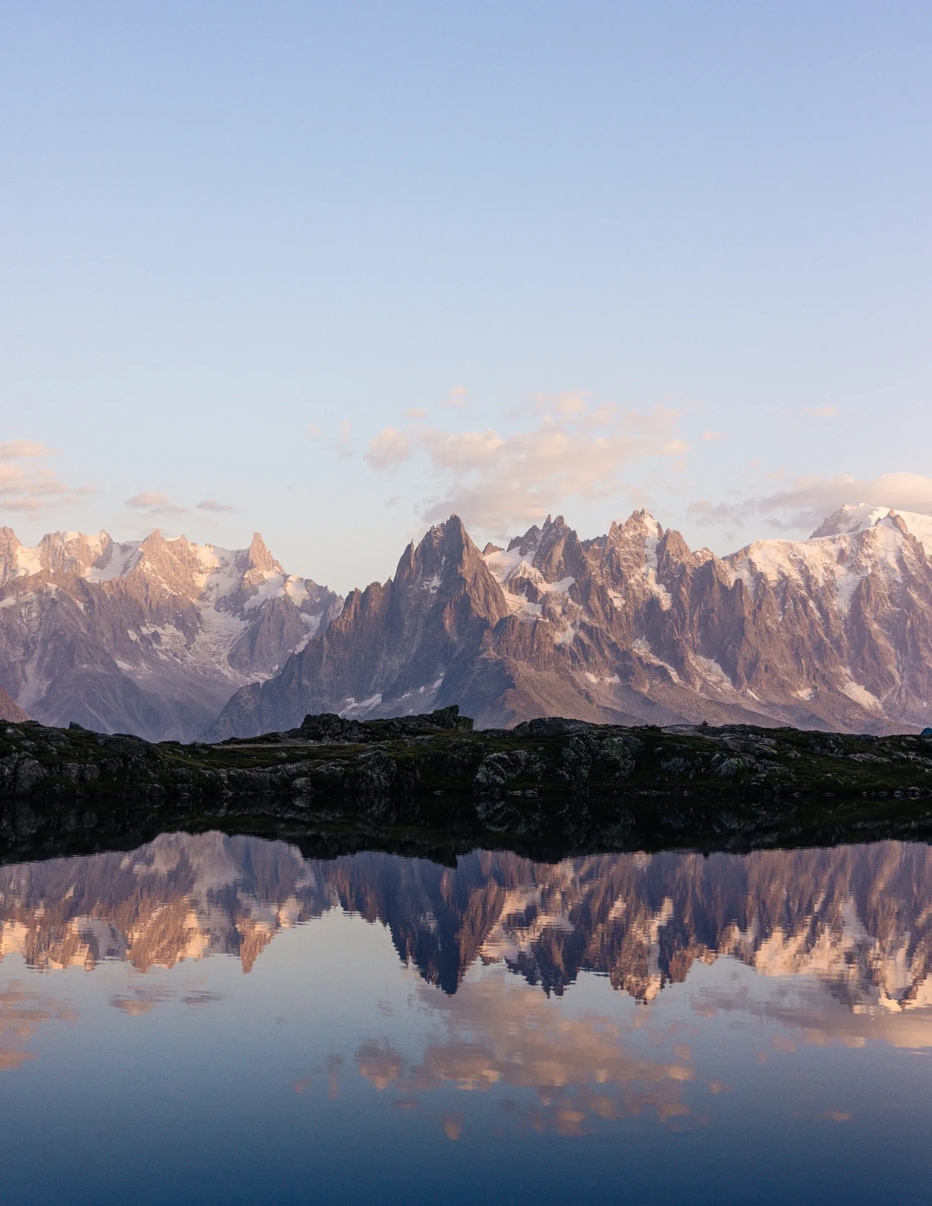 A vertical view of mountain peaks reflected in Lac Blanc