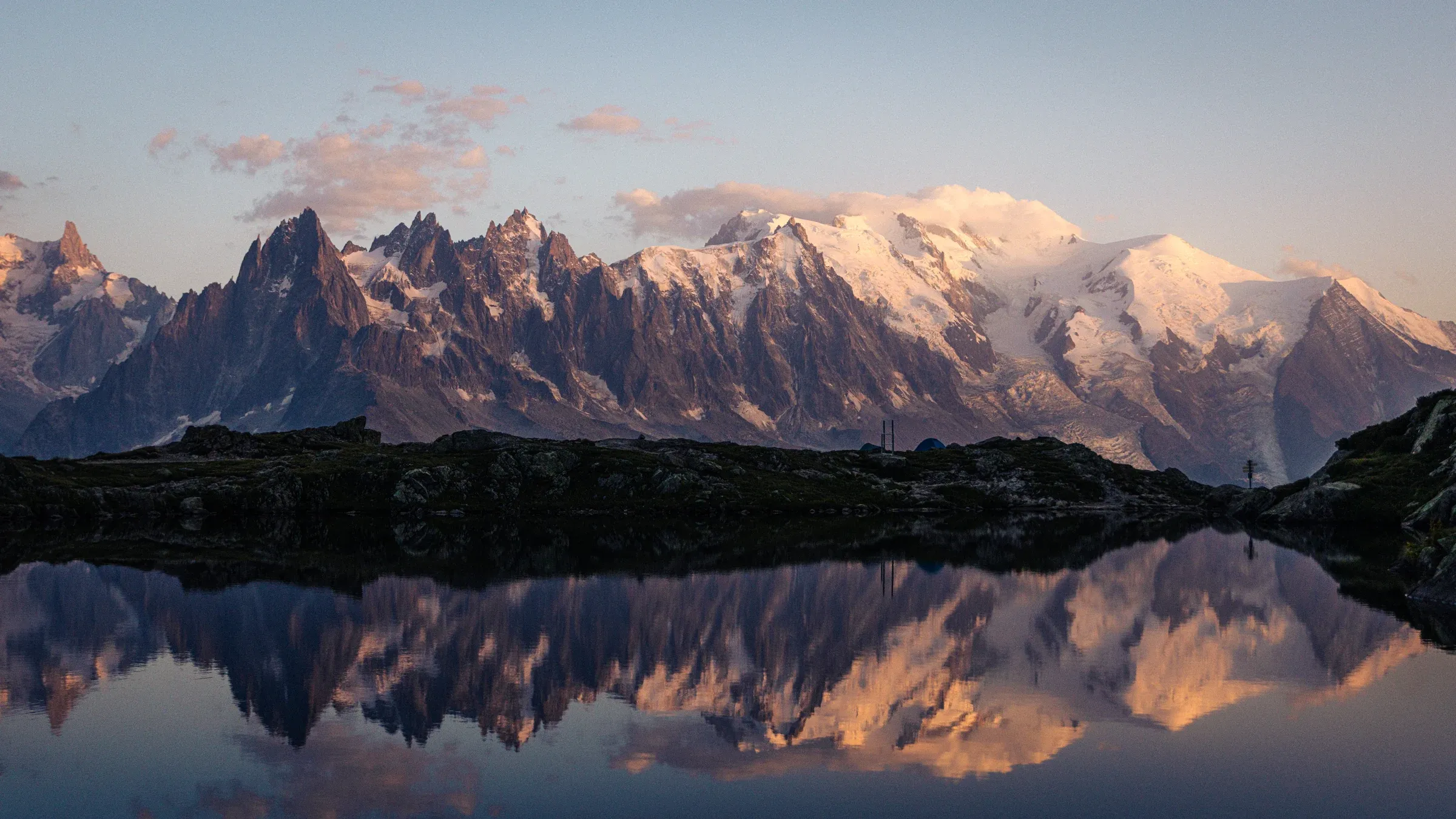 Snow-covered mountains reflected in the still water of Lac Blanc