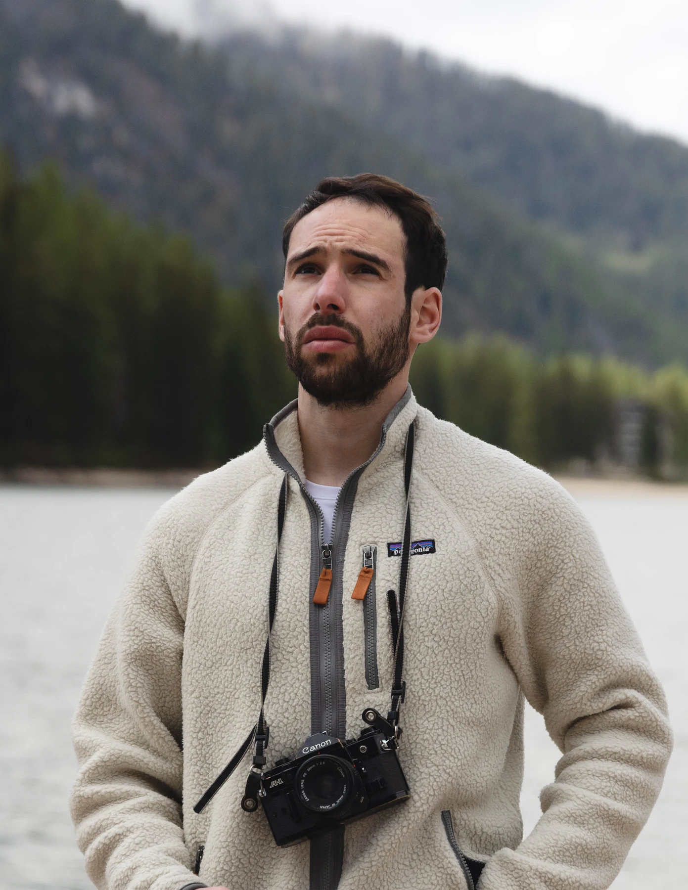 Sam with his camera beside a mountain lake